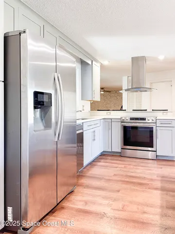 a kitchen with stainless steel appliances a refrigerator sink and cabinets