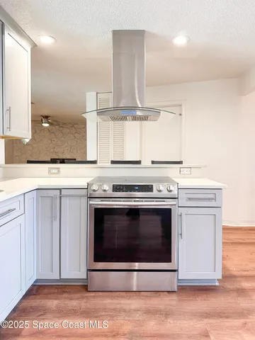 a stove top oven sitting inside of a kitchen