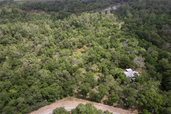 an aerial view of a houses with yard
