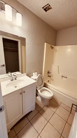 a bathroom with a double vanity sink toilet mirror and bathtub
