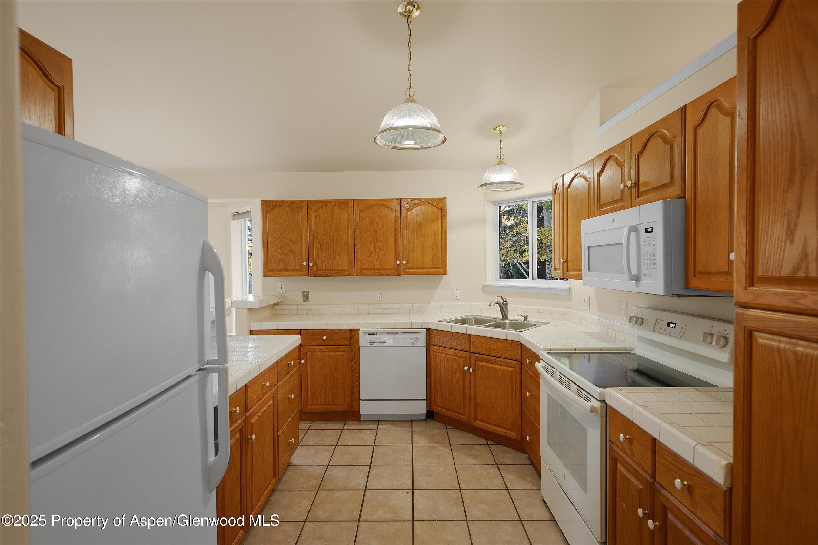 634 East First Street New Castle, CO 81647 - Photo 17 of 46 a large kitchen with stainless steel appliances granite countertop a sink and cabinets