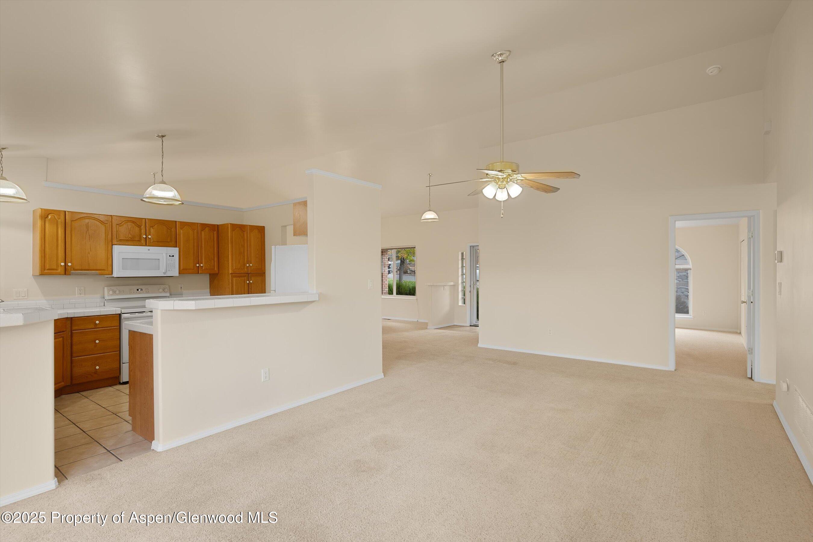 634 East First Street New Castle, CO 81647 - Photo 20 of 46 a view of a kitchen with a sink and a refrigerator