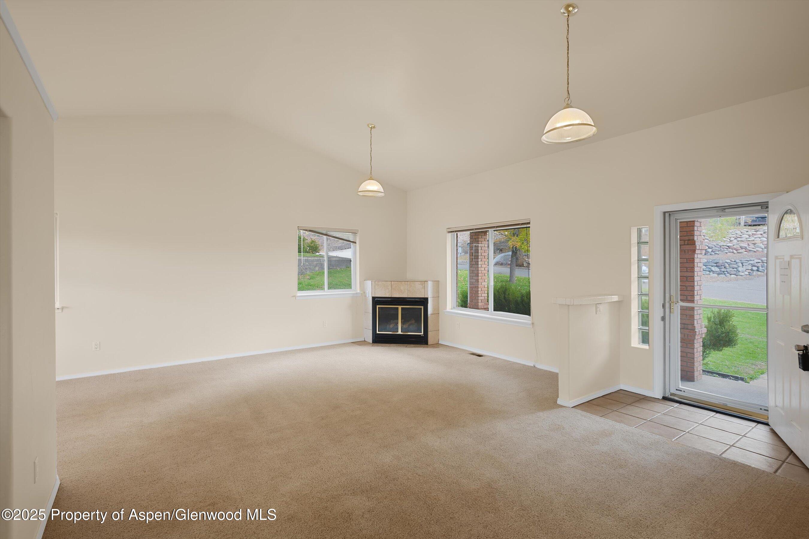 634 East First Street New Castle, CO 81647 - Photo 21 of 46 a view of a livingroom with an empty space and a fireplace
