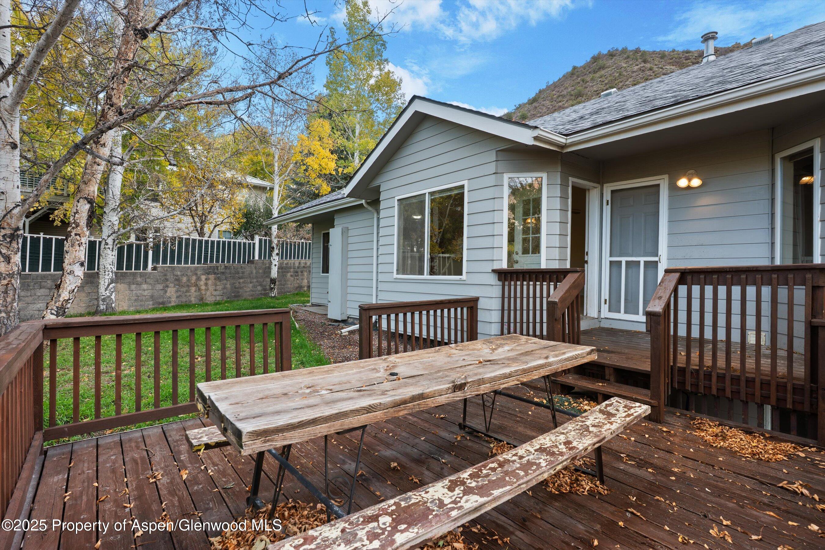 634 East First Street New Castle, CO 81647 - Photo 37 of 46 a view of a deck with a table chairs and wooden fence