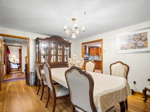 a view of a dining room with furniture and chandelier