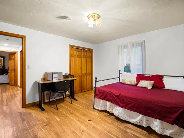 a bedroom with a bed and a chandelier