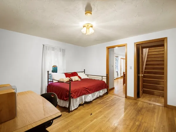 a bedroom with two beds and a chandelier