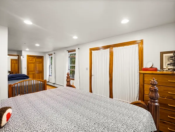 a bedroom with a large bed and a large window