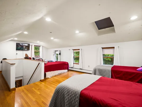 a bedroom with two beds and a window