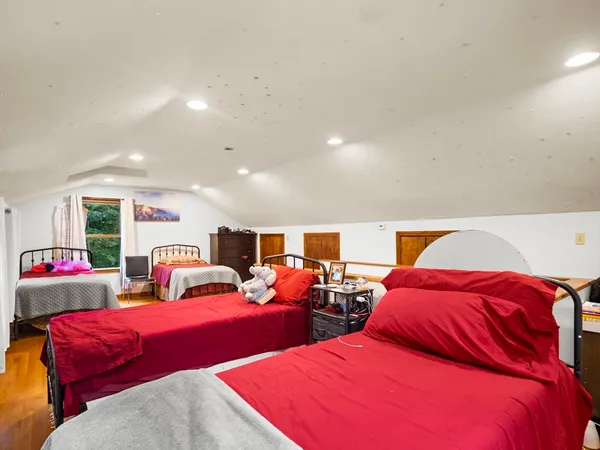 a bedroom with two beds and a couch