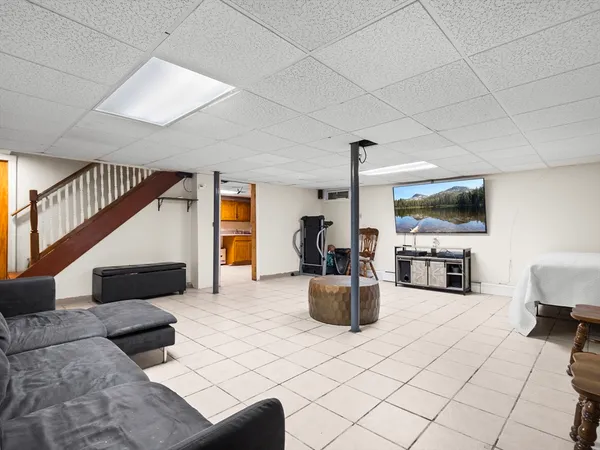 a living room with fireplace furniture and a flat screen tv