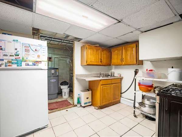 a kitchen with stainless steel appliances granite countertop a refrigerator and a stove top oven