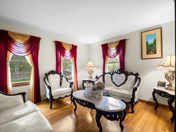 a living room with furniture a rug and a large window