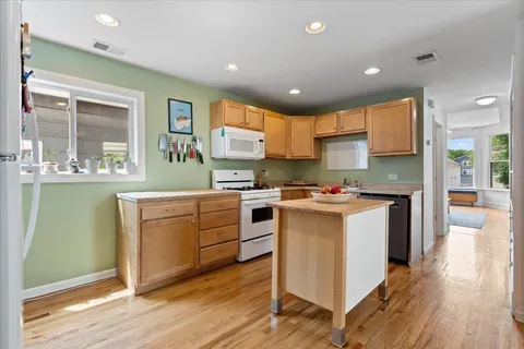 a kitchen with stainless steel appliances granite countertop a stove and a refrigerator
