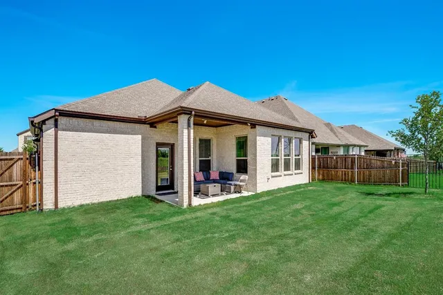 a view of a house with a yard and porch
