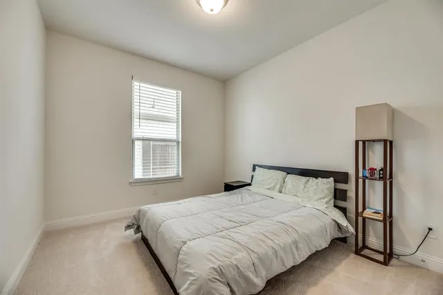 a bedroom with a bed and a night stand