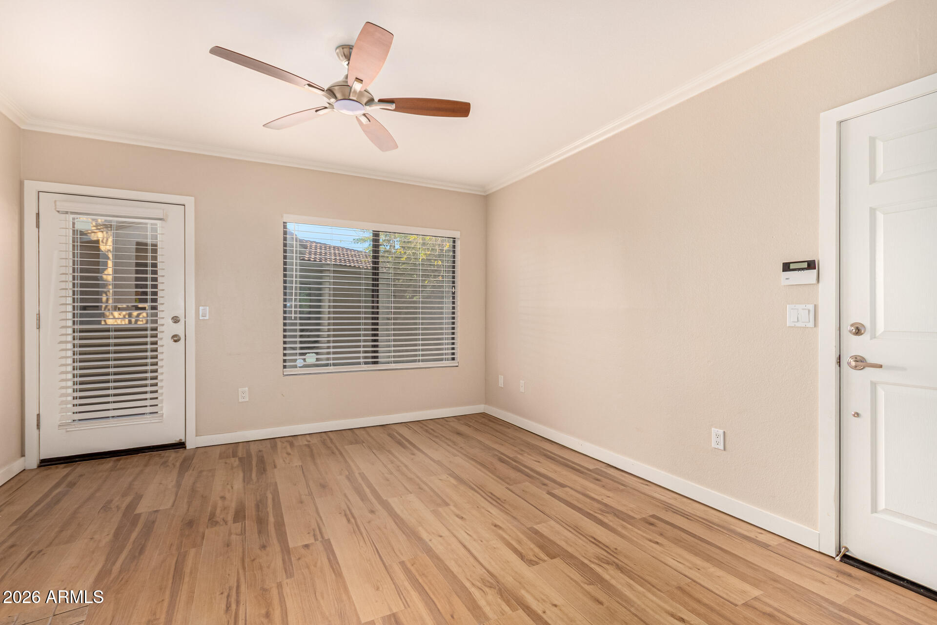 a view of room with window ceiling fan and wooden floor