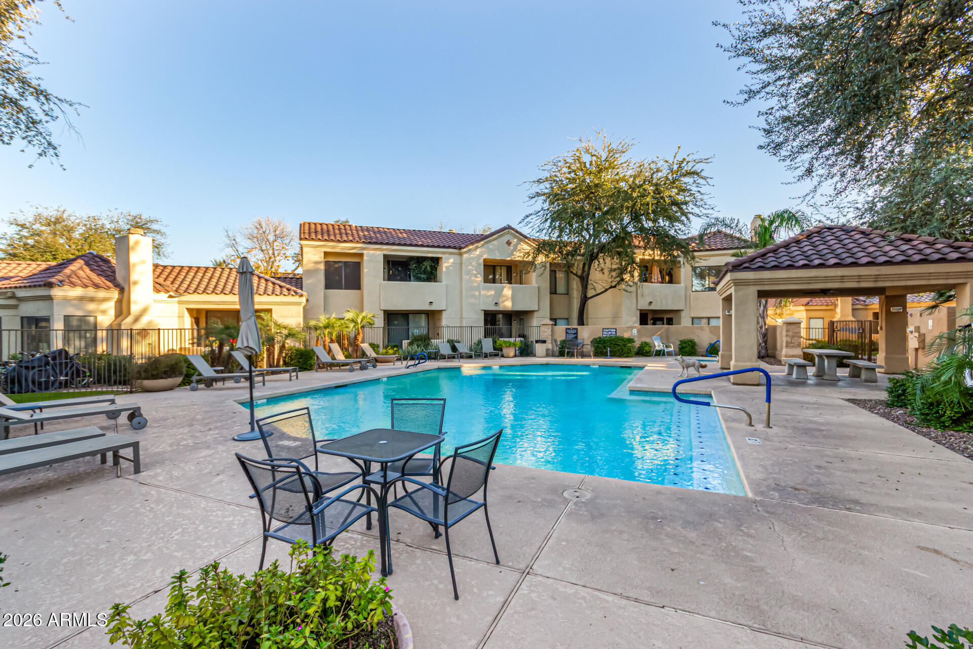 7575 East Indian Bend Road, Unit 2036 Scottsdale, AZ 85250 - Photo 19 of 29 a swimming pool view with a seating space and a garden view