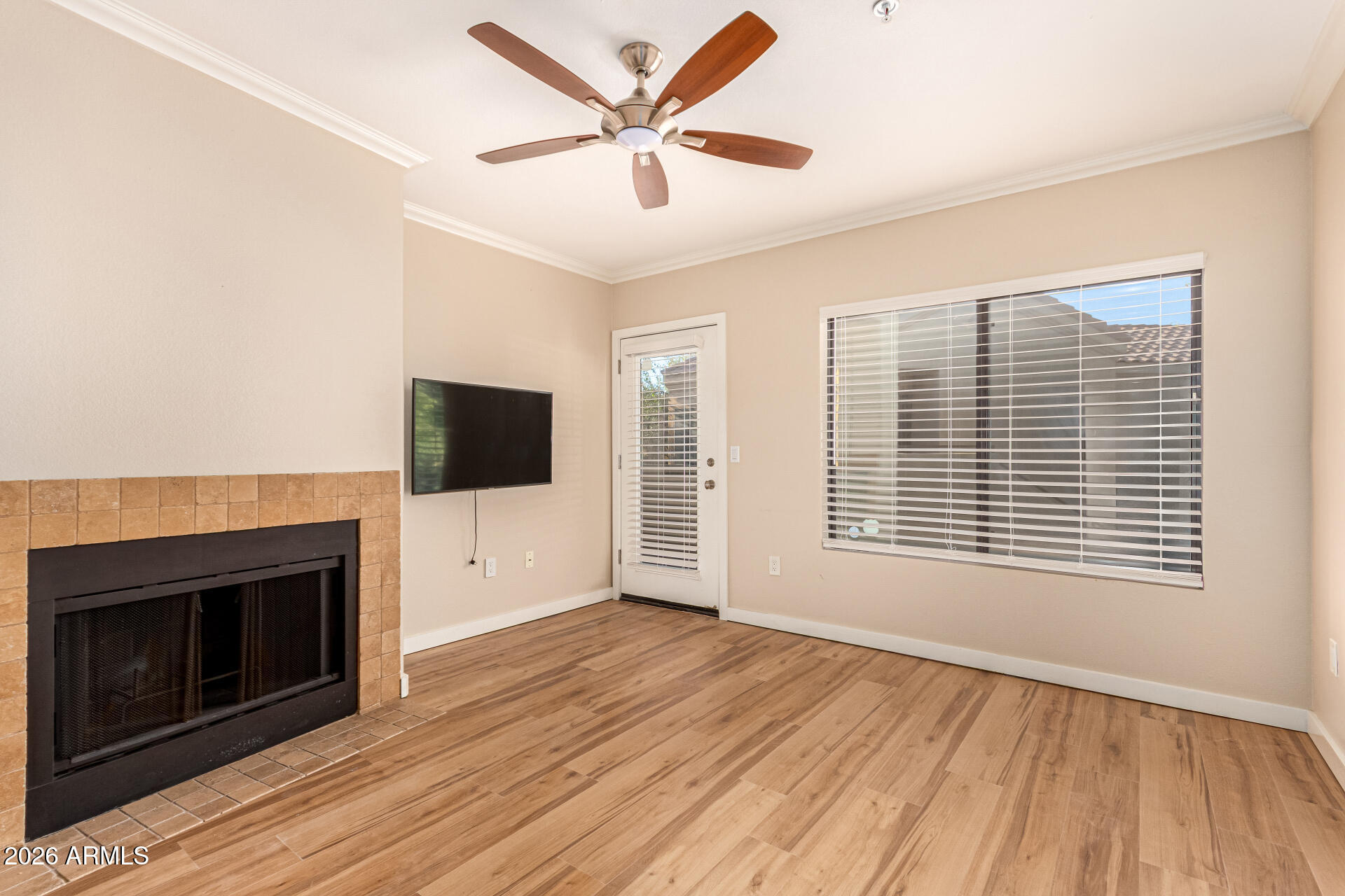 7575 East Indian Bend Road, Unit 2036 Scottsdale, AZ 85250 - Photo 2 of 29 a view of an empty room with wooden floor a fireplace and a window
