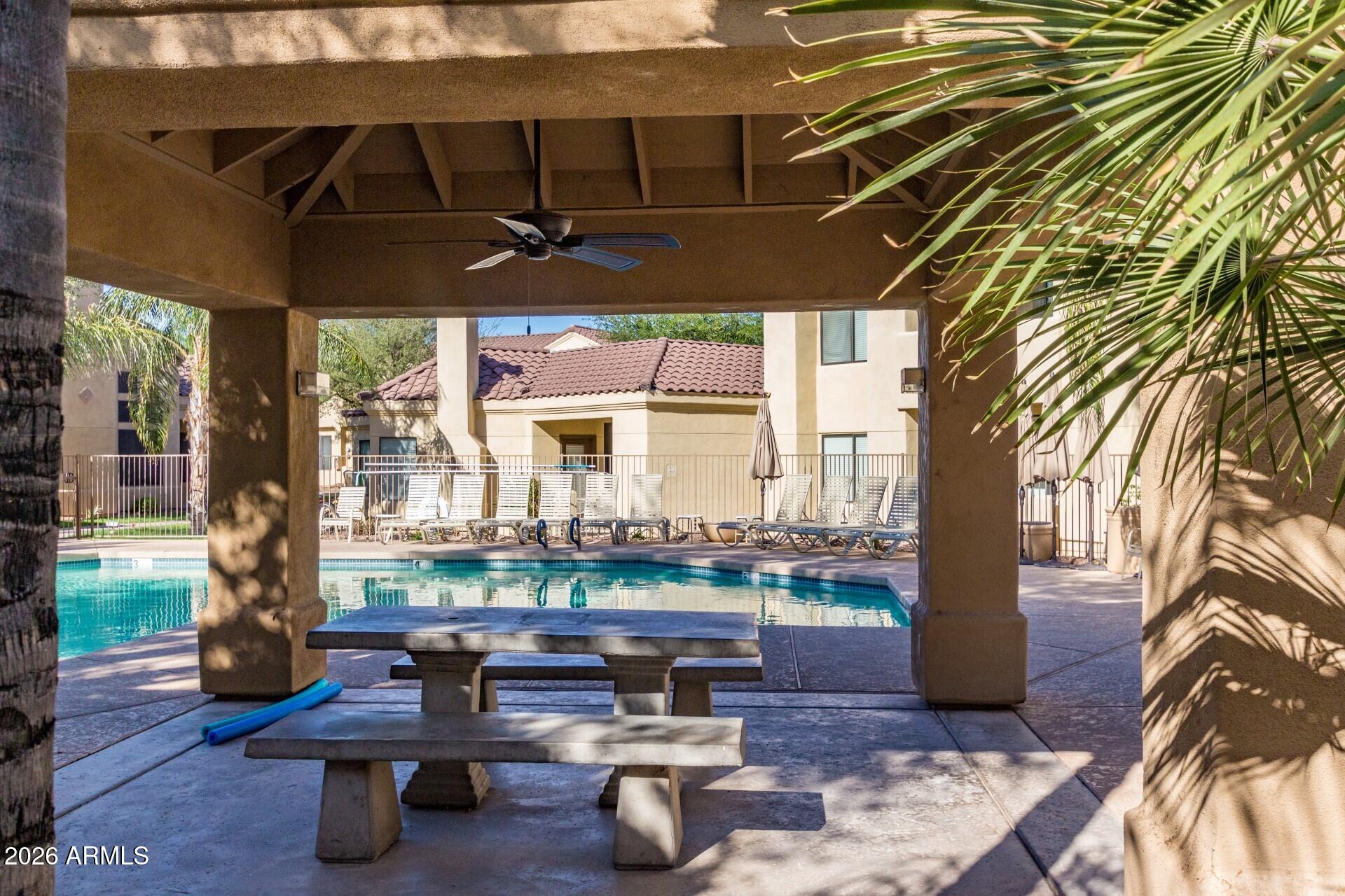 7575 East Indian Bend Road, Unit 2036 Scottsdale, AZ 85250 - Photo 25 of 29 a living room filled with furniture and a table