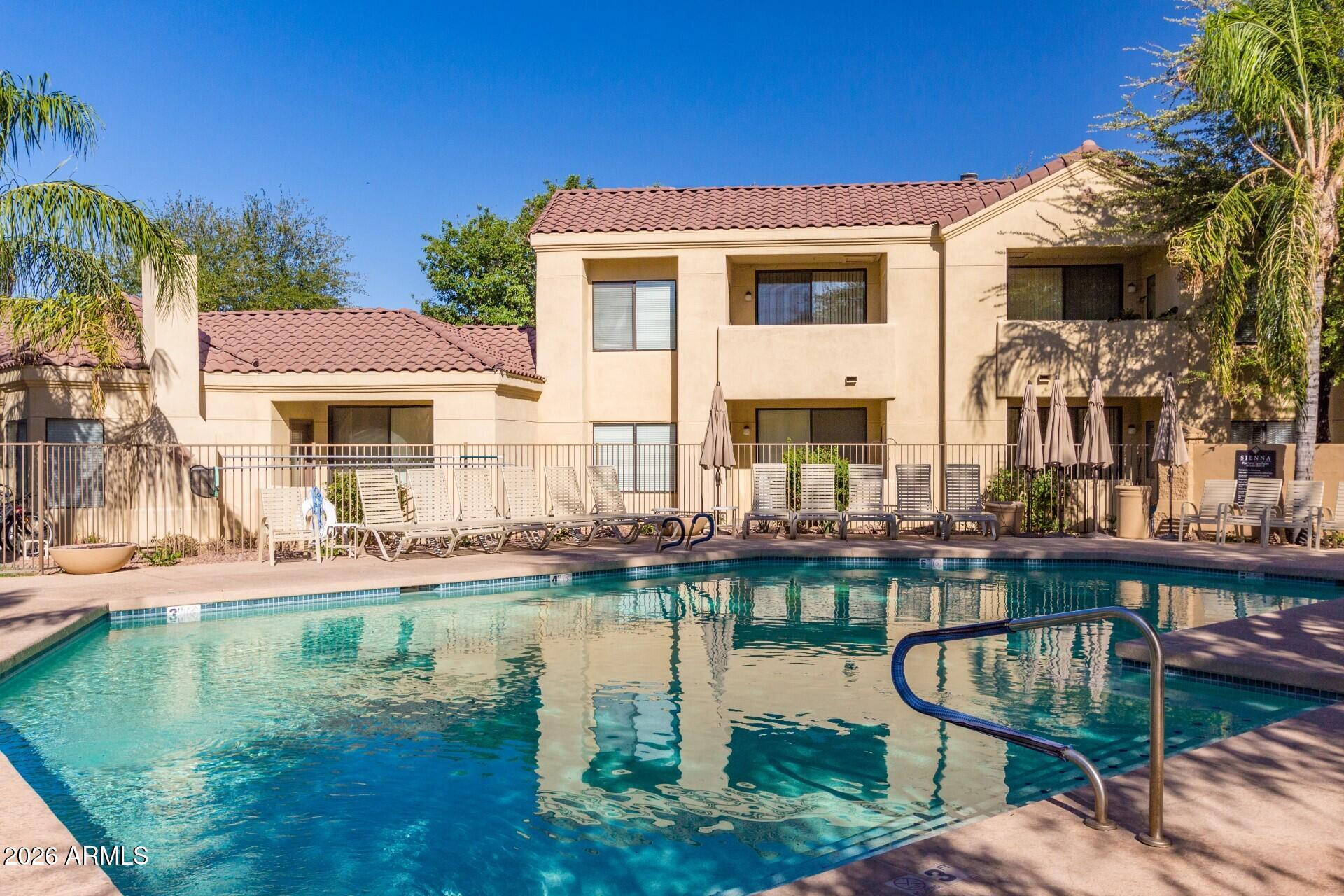 7575 East Indian Bend Road, Unit 2036 Scottsdale, AZ 85250 - Photo 26 of 29 a front view of a house with garden and swimming pool