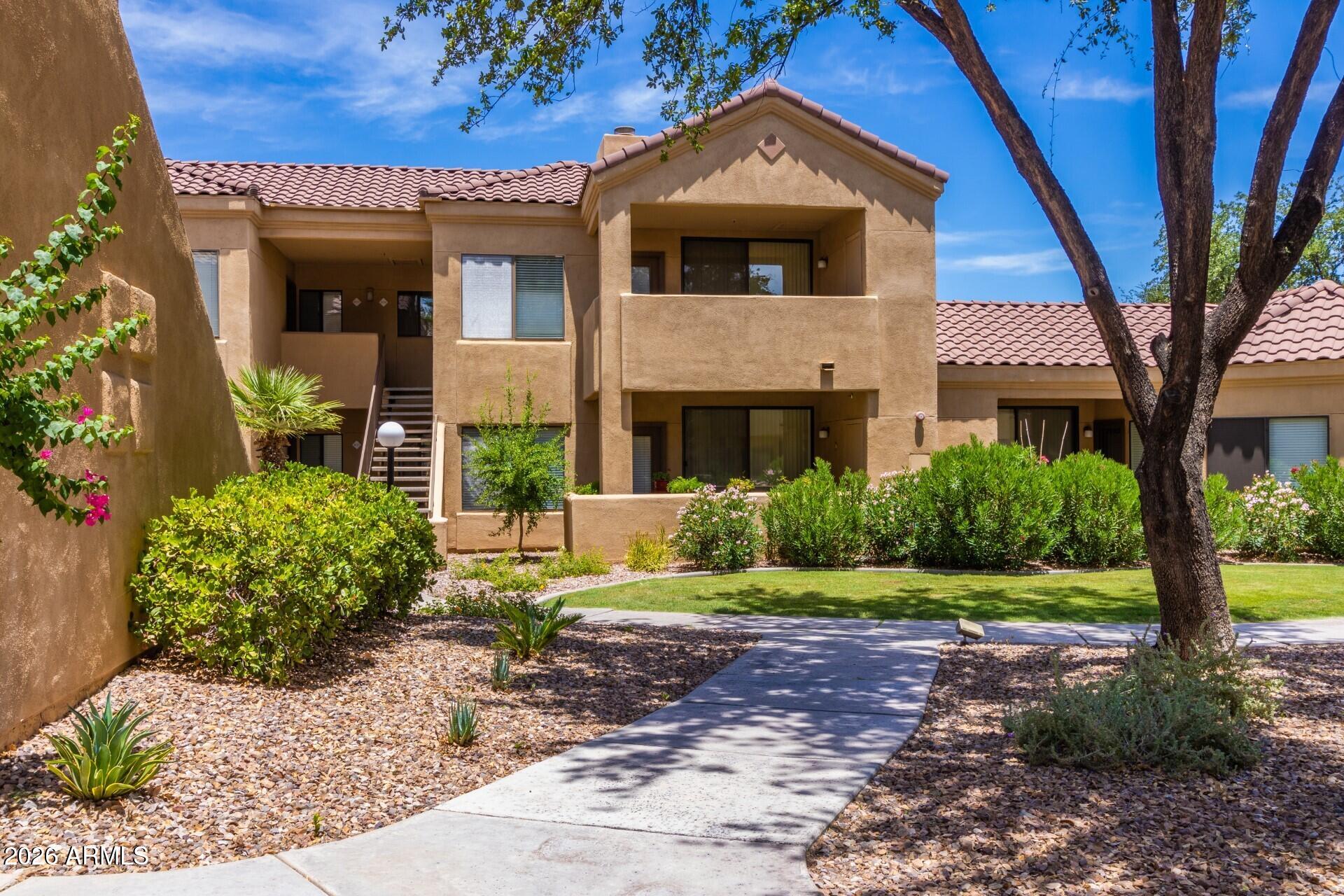 7575 East Indian Bend Road, Unit 2036 Scottsdale, AZ 85250 - Photo 27 of 29 a front view of a house with a yard