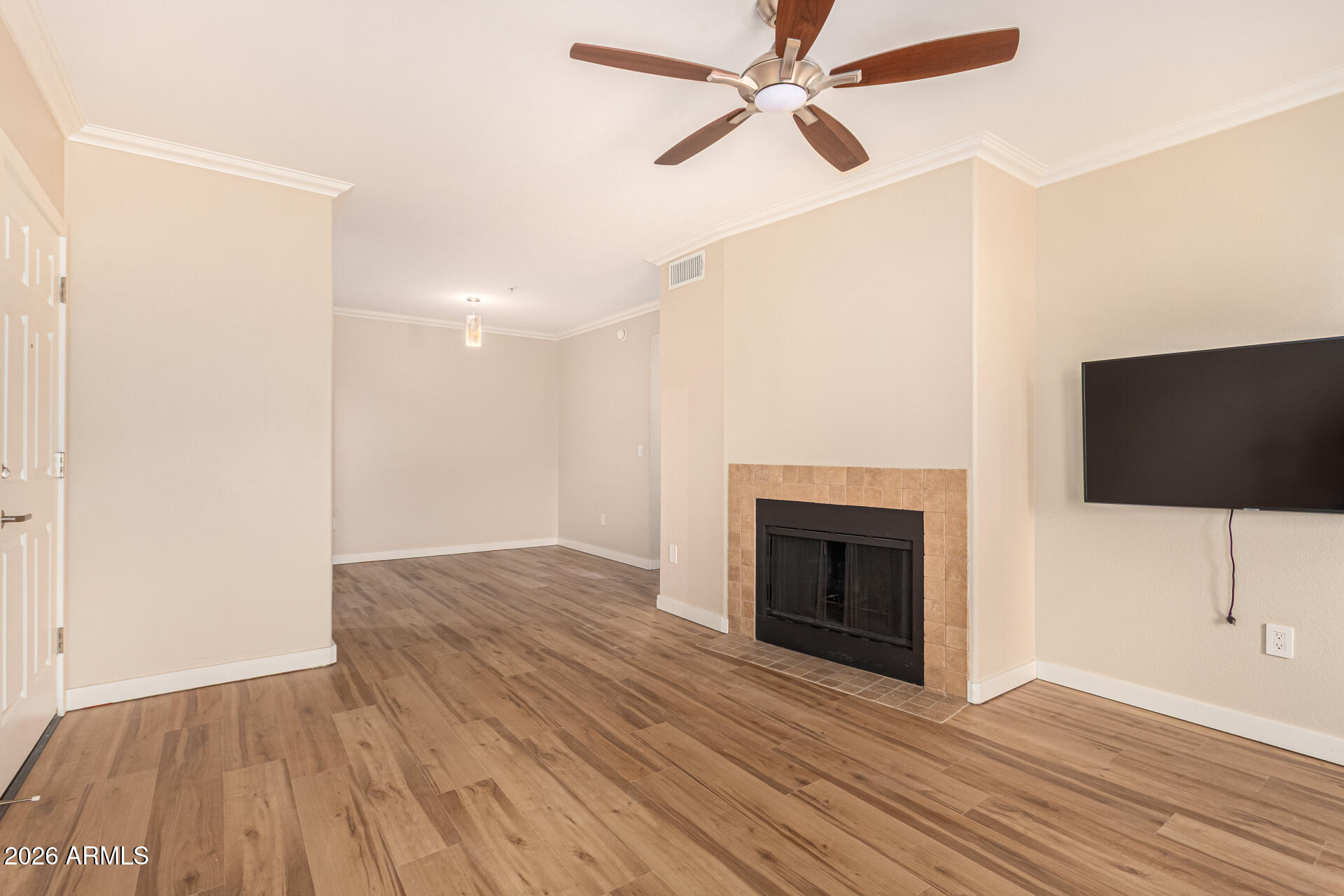 7575 East Indian Bend Road, Unit 2036 Scottsdale, AZ 85250 - Photo 3 of 29 a view of an empty room with wooden floor fireplace and a window