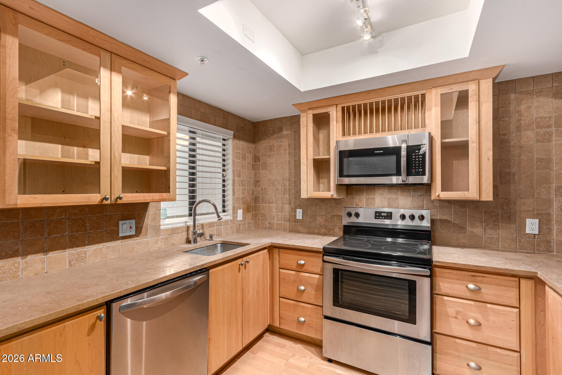 7575 East Indian Bend Road, Unit 2036 Scottsdale, AZ 85250 - Photo 10 of 29 a kitchen with stainless steel appliances a stove sink microwave and cabinets