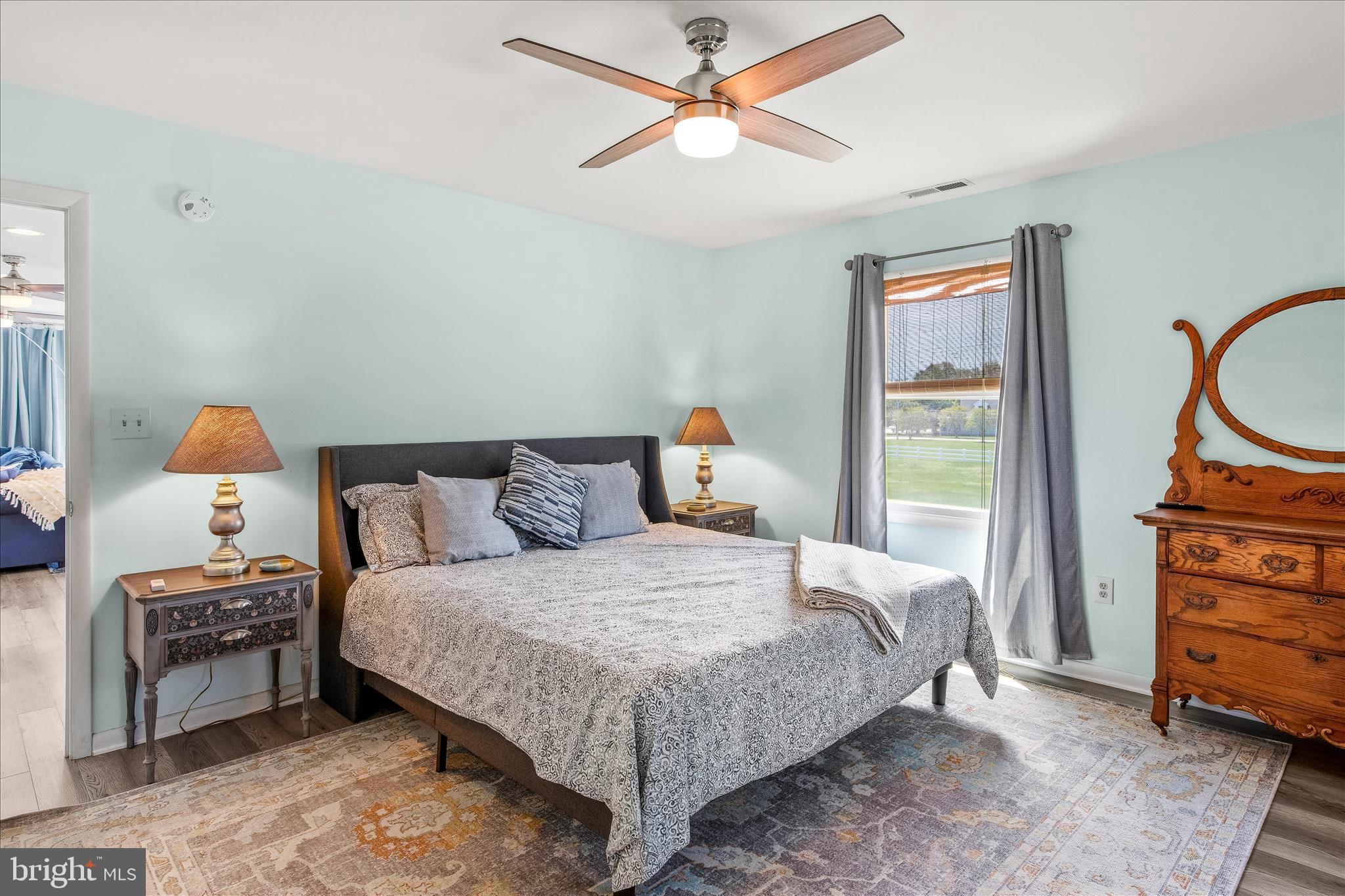 21406 Dogwood Cove Road Tilghman, MD 21671 - Photo 39 of 68 a bedroom with a bed a dresser and a chandelier