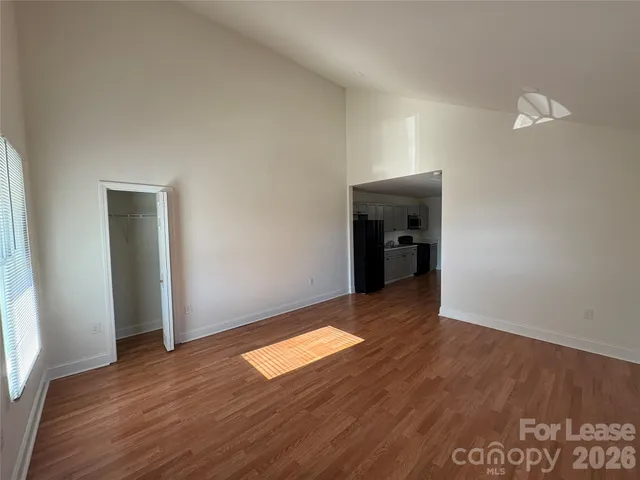 an empty room with wooden floor and closet