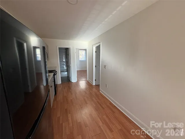 a view of hallway with wooden floor