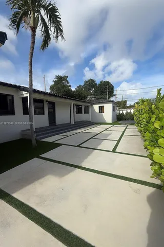 a house with palm tree in the background