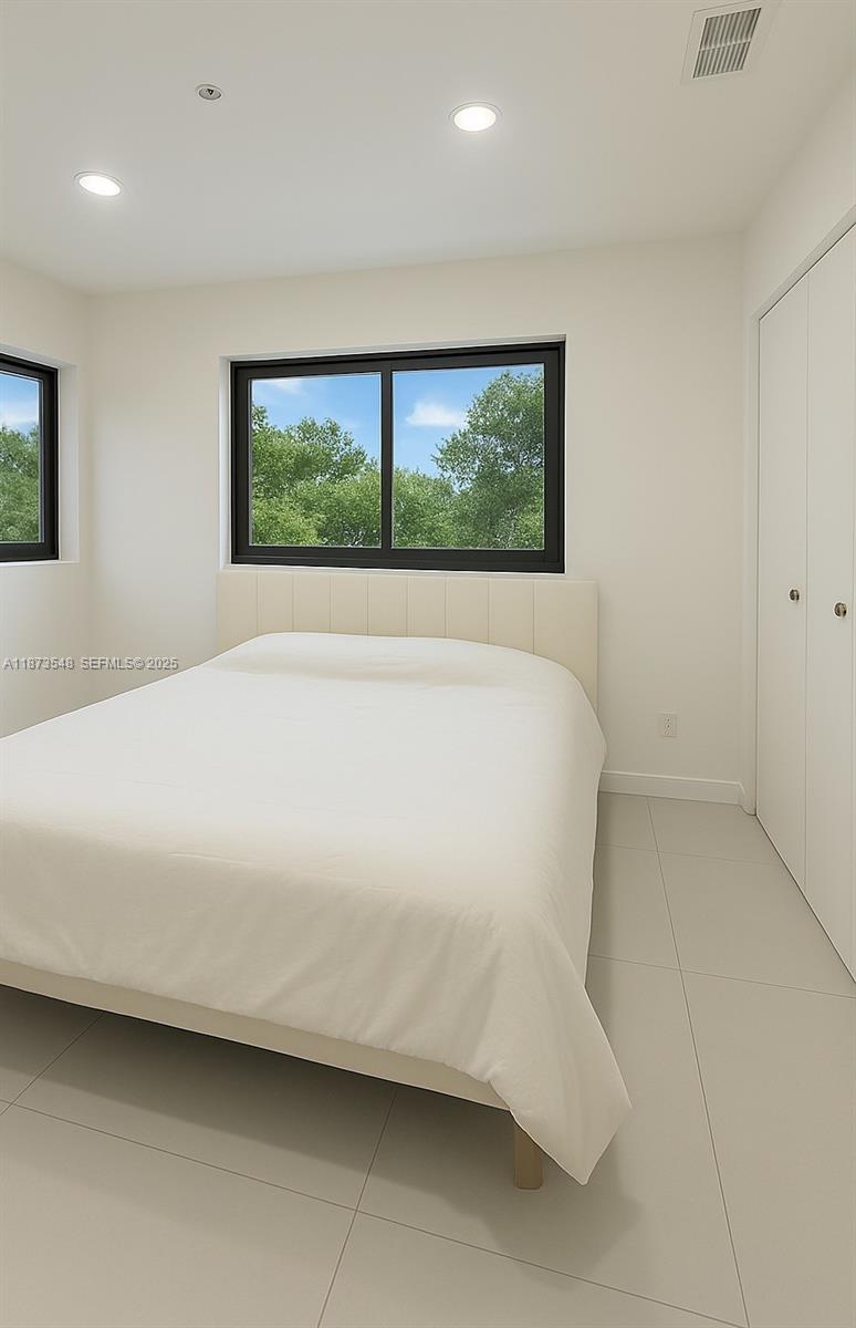 621 Southwest 33rd Avenue Miami, FL 33135 - Photo 6 of 6 a large white bed in a white room