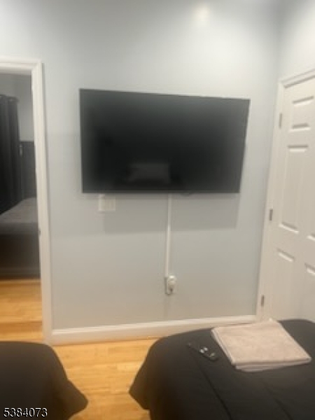 753 South 11th Street Newark, NJ 07103 - Photo 2 of 10 a bedroom with a bed and a flat screen tv