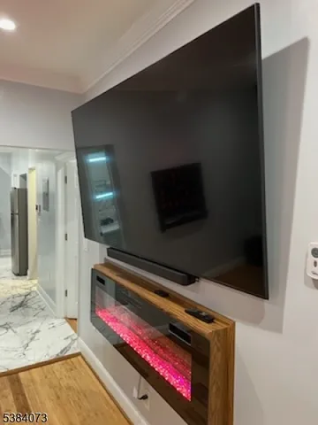 a living room with a flat screen tv and a fireplace