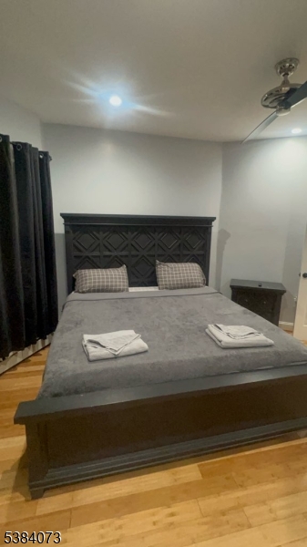 753 South 11th Street Newark, NJ 07103 - Photo 9 of 10 a bedroom with a bed and wooden floor