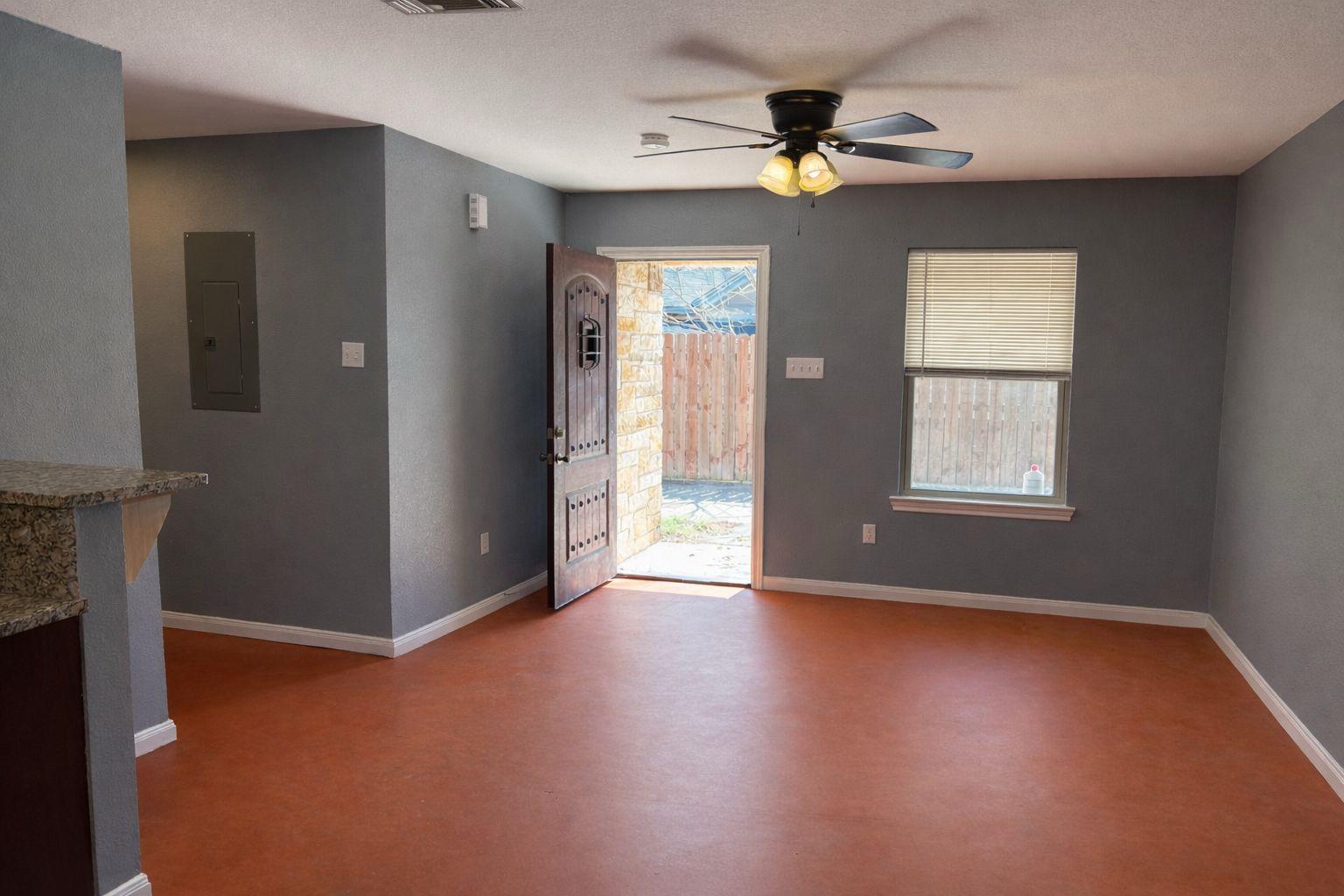 1403 Strickland Street Waco, TX 76705 - Photo 2 of 11 wooden floor in an empty room with a window