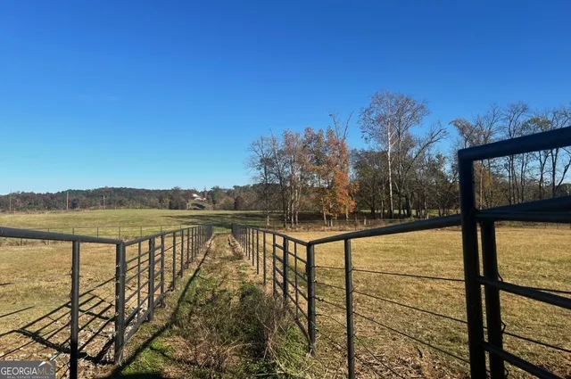 a view of a field with an ocean view