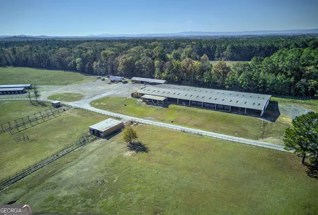 an aerial view of a house with a swimming pool