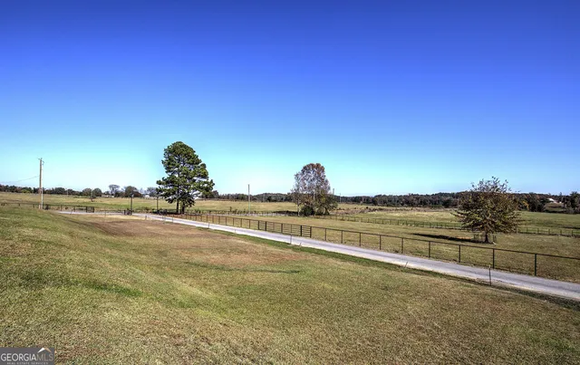 a view of a lake with trees and houses in the background