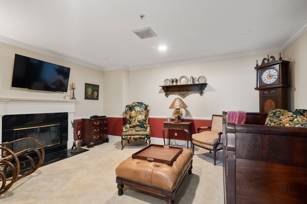 197 8th Street, Unit 711 Boston, MA 02129 - Photo 13 of 24 a living room with furniture a fireplace and flat screen tv