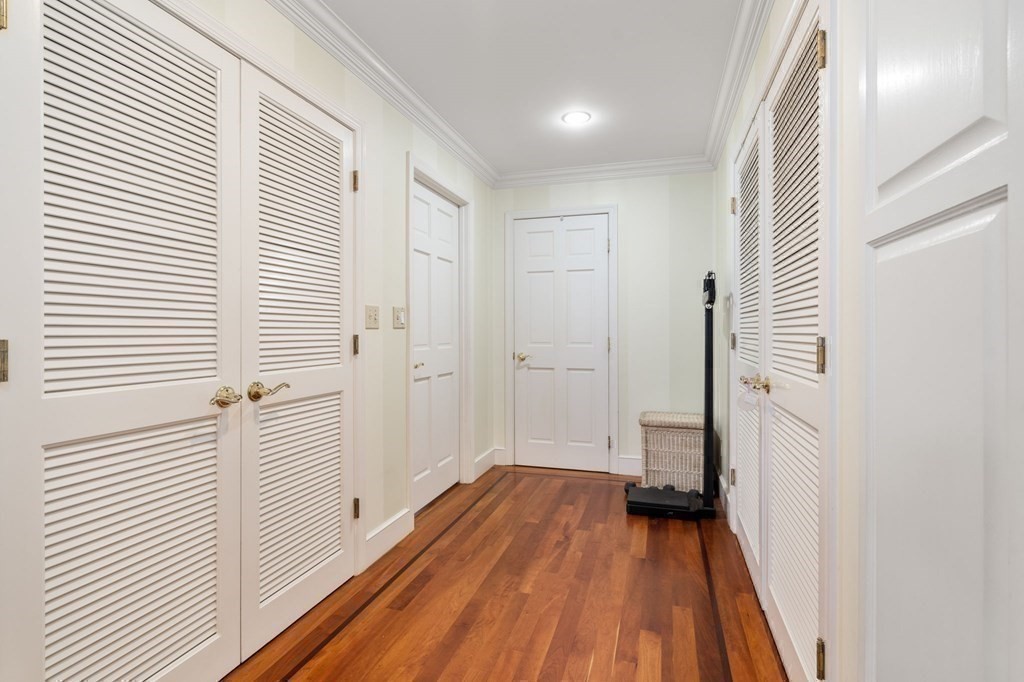 197 8th Street, Unit 711 Boston, MA 02129 - Photo 14 of 24 a view of a hallway with wooden floor and staircase