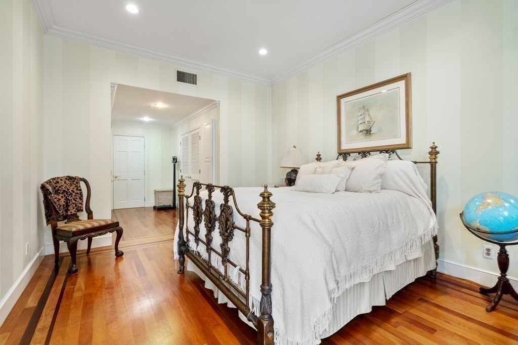 197 8th Street, Unit 711 Boston, MA 02129 - Photo 15 of 24 a spacious bedroom with a bed and chair