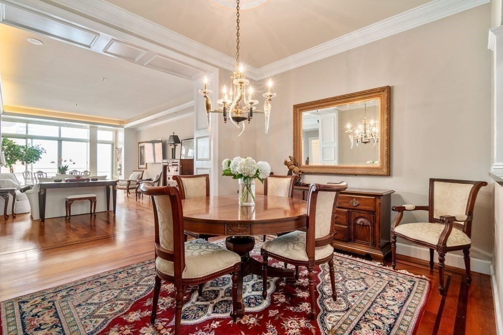 197 8th Street, Unit 711 Boston, MA 02129 - Photo 9 of 24 a dining room with furniture a chandelier and wooden floor