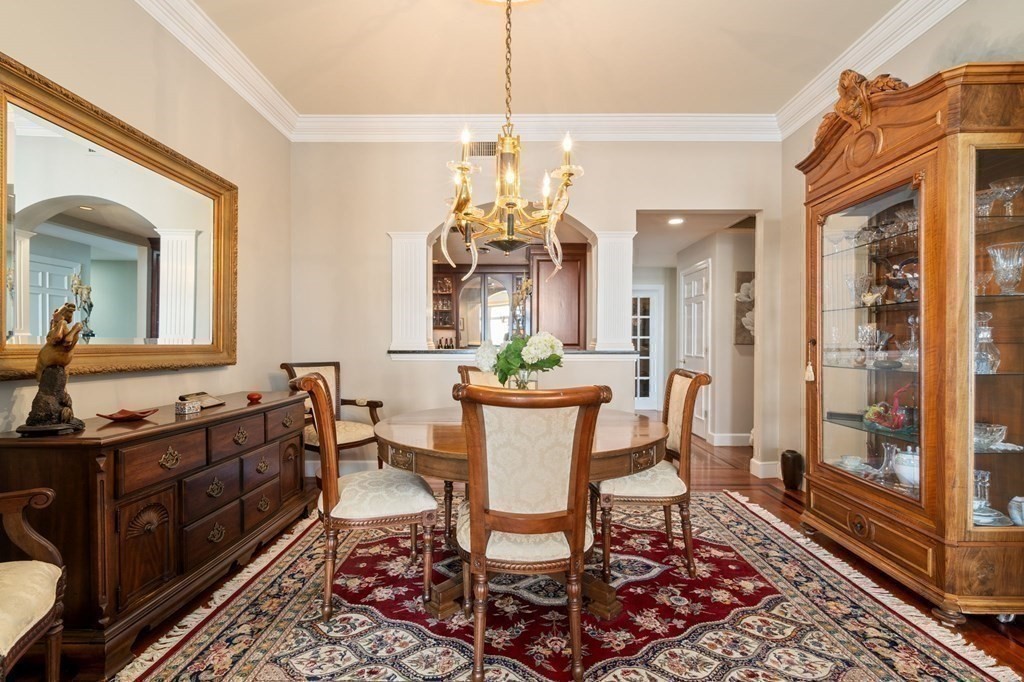 197 8th Street, Unit 711 Boston, MA 02129 - Photo 10 of 24 a dining room with furniture a chandelier and wooden floor