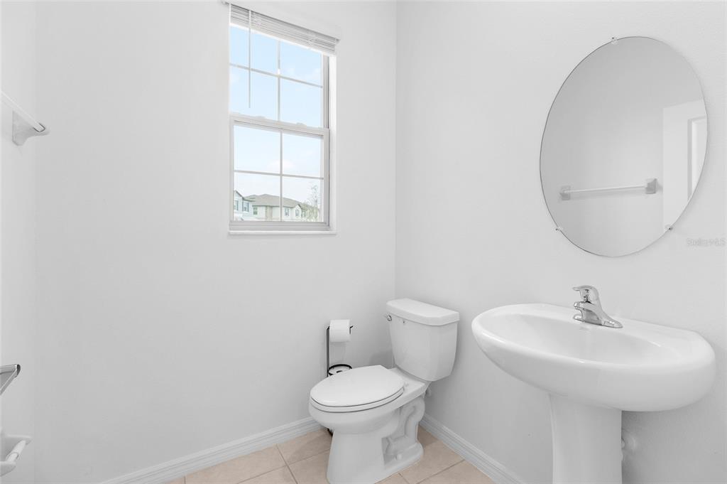 14450 Easy Goer Street Ruskin, FL 33573 - Photo 12 of 27 a bathroom with a toilet sink and mirror