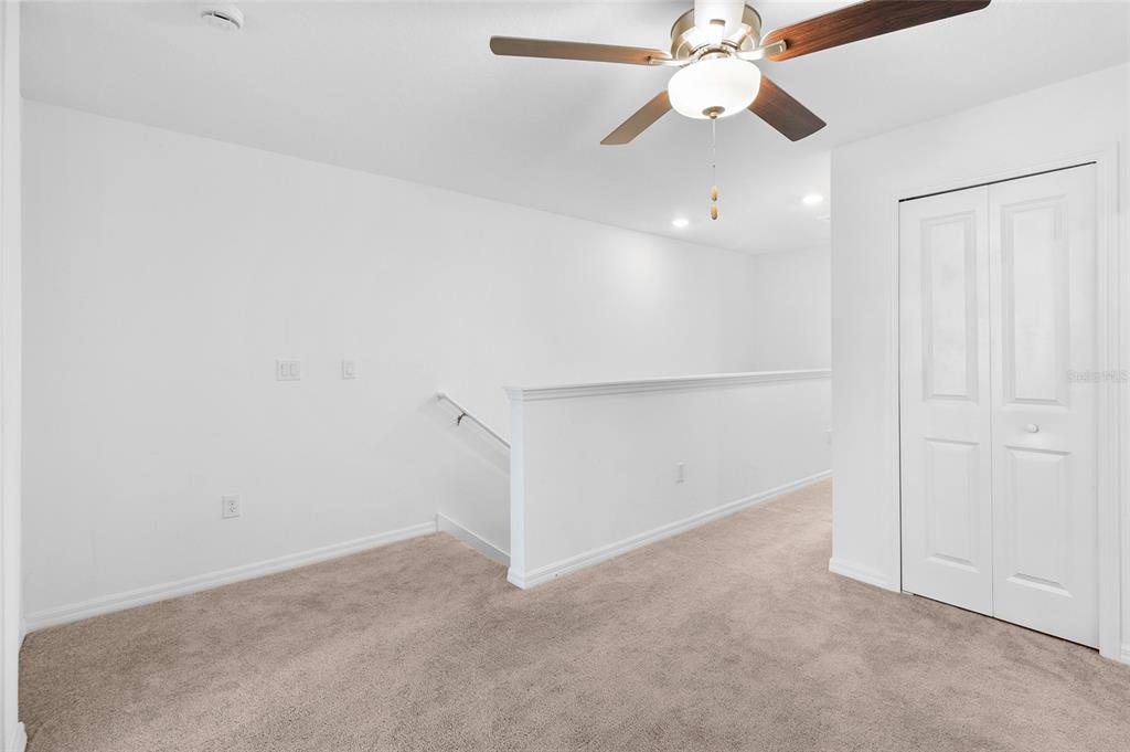 14450 Easy Goer Street Ruskin, FL 33573 - Photo 14 of 27 an empty room with closet and a chandelier fan