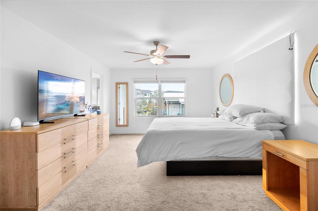 14450 Easy Goer Street Ruskin, FL 33573 - Photo 16 of 27 a spacious bedroom with a bed and a flat screen tv