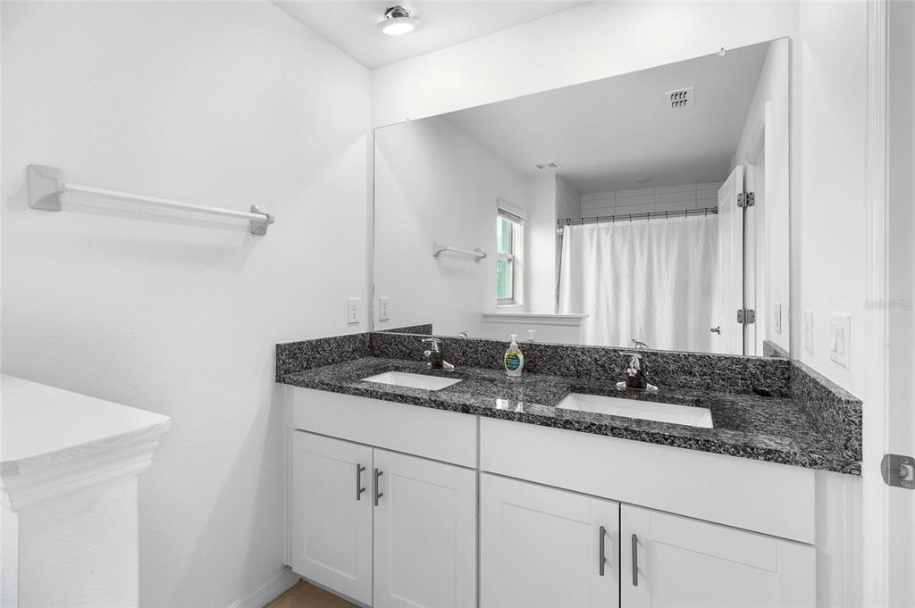 14450 Easy Goer Street Ruskin, FL 33573 - Photo 19 of 27 a bathroom with a granite countertop sink and a mirror