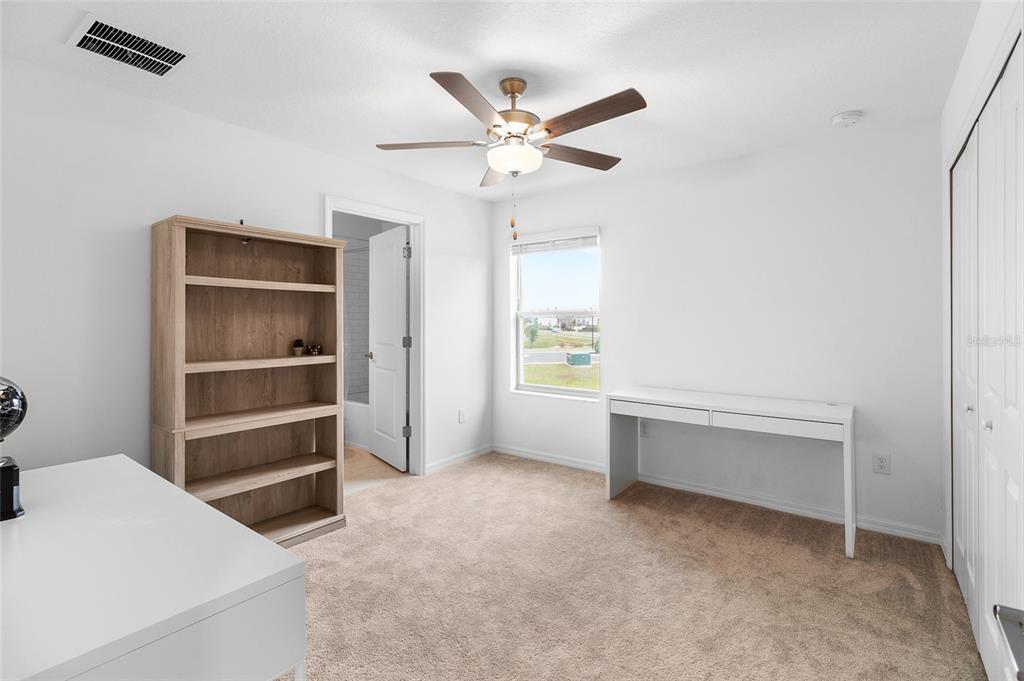 14450 Easy Goer Street Ruskin, FL 33573 - Photo 20 of 27 a livingroom with a ceiling fan and a window